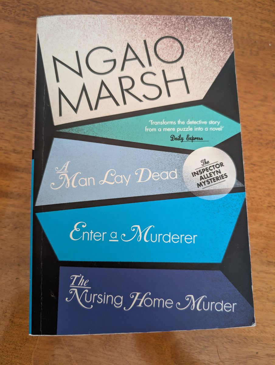 A photograph of the front cover of the 2009 paperback edition of Harper's Ngaio Marsh omnibus, containing 'A Man Lay Dying', 'Enter a Murderer' and 'The Nursing Home Murder'. The book is in good condition, with a faint crease on the front cover.