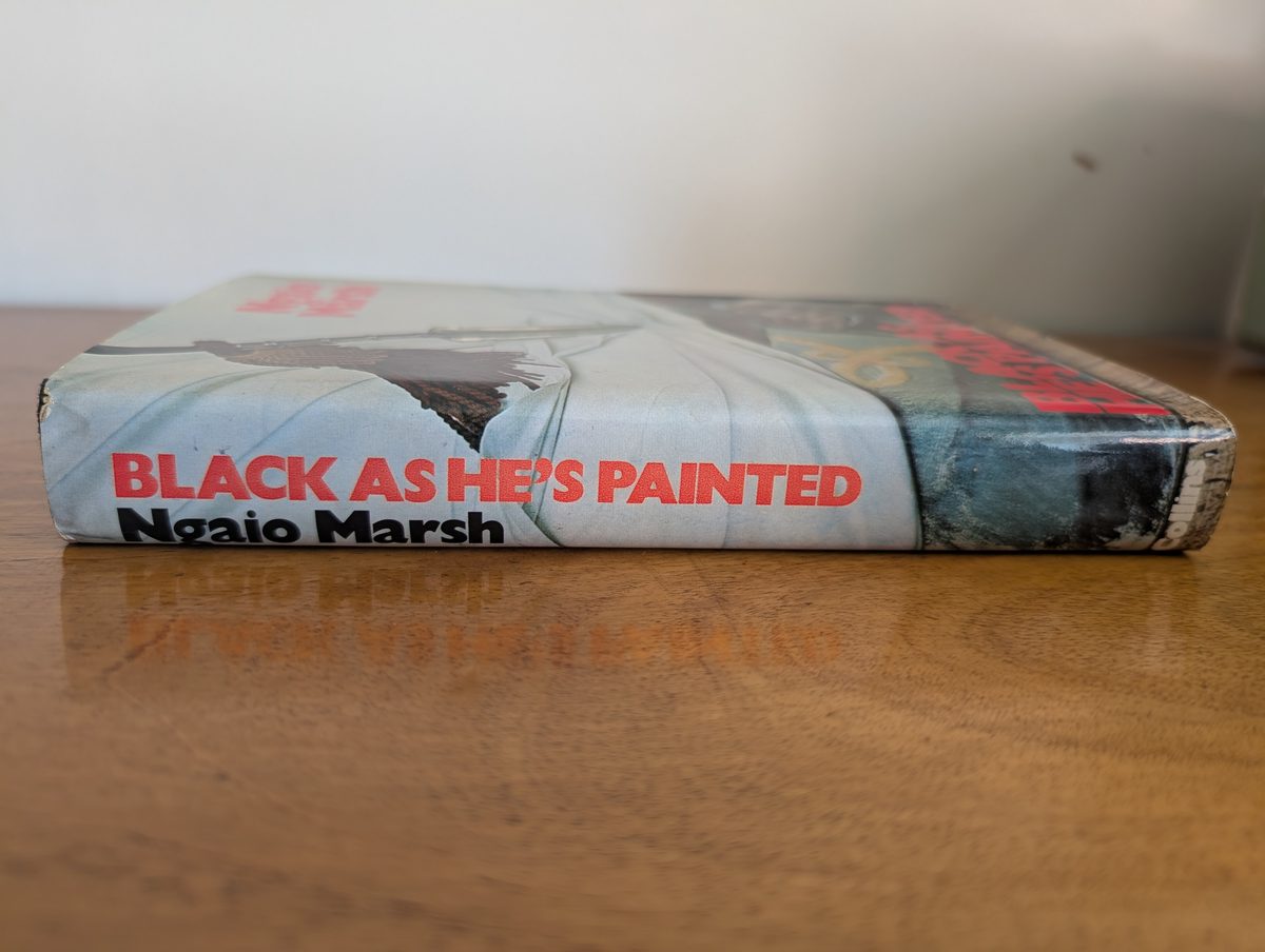 A photograph of the spine of the 1974 UK hardback first edition of Ngaio Marsh's Black As He's Painted.