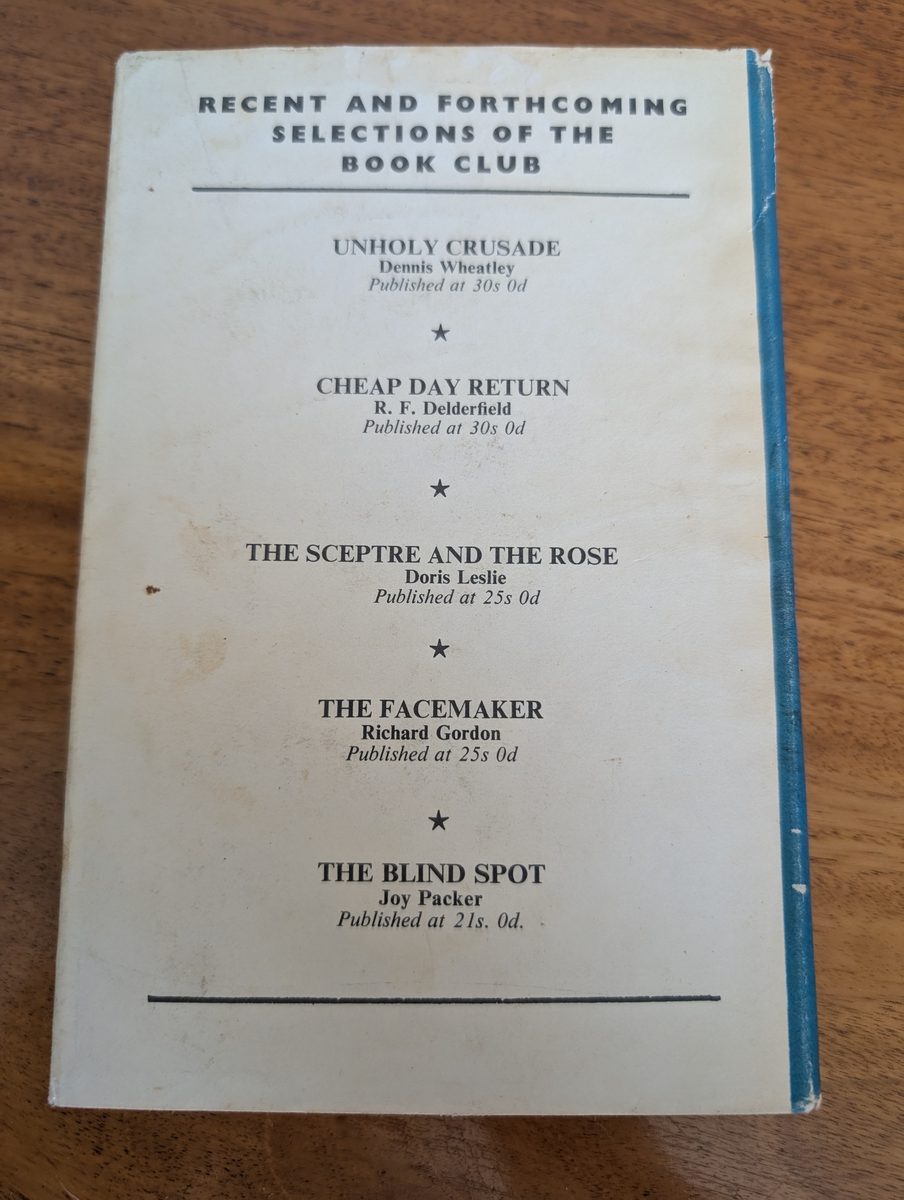 A photograph of the back cover of the 1967 Collins Crime Club hardback edition of Ngaio Marsh's Death at the Dolphin. It shows some wear and tear to the dust jacket.