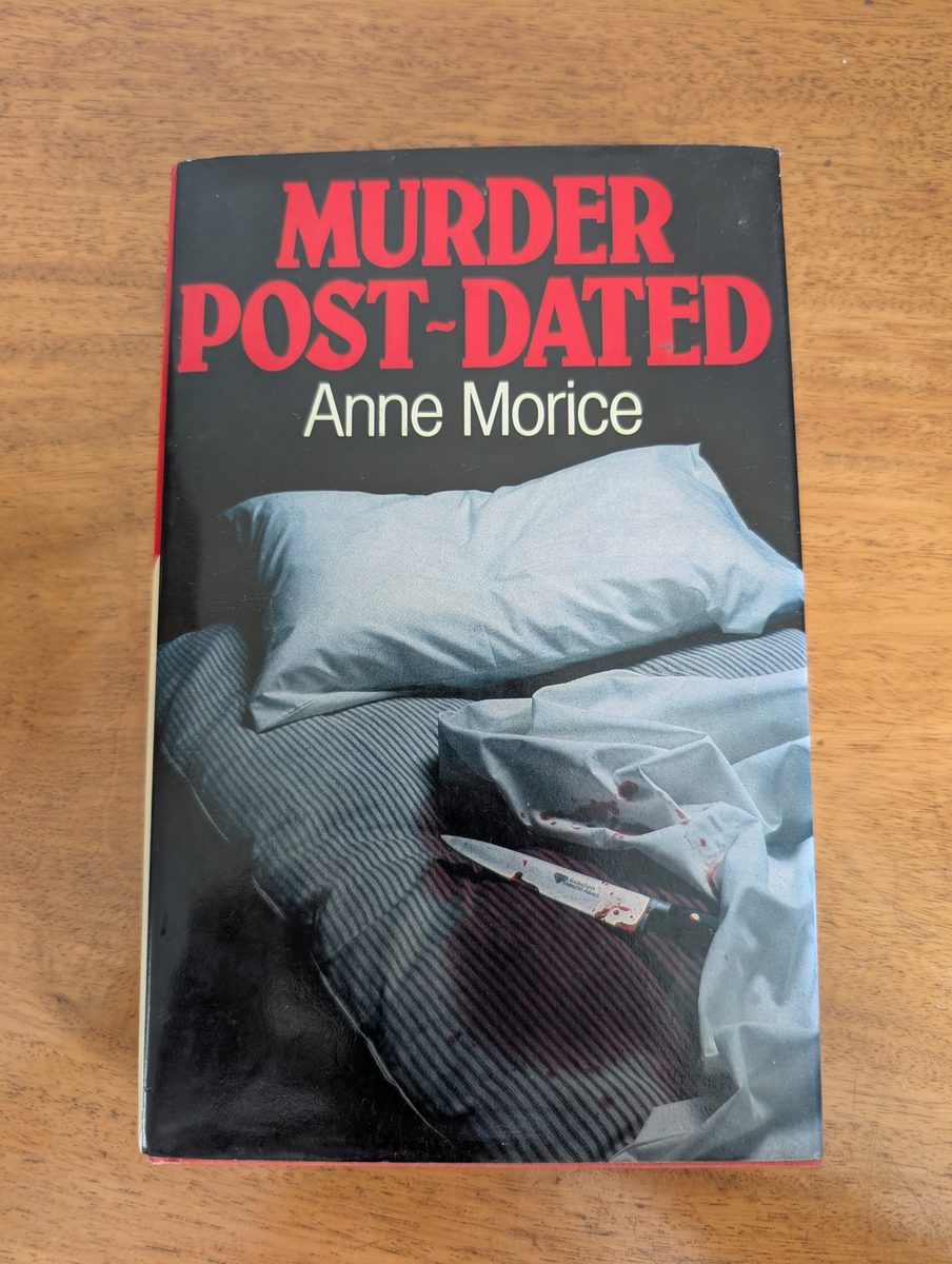 Front cover of Murder Post-Dated by Anne Morice, Macmillan 1983 hardback with dust jacket