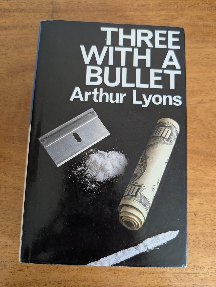 Front cover of Three With a Bullet by Arthur Lyons, Macmillan 1987 hardback with dust jacket